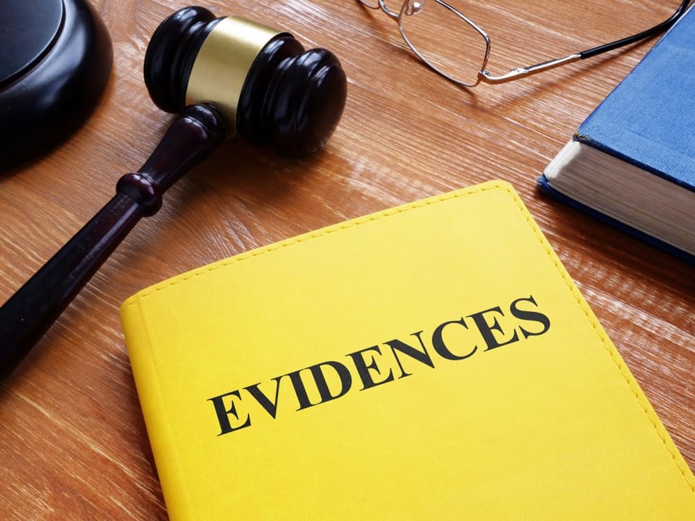 Close-up of evidence documents and a gavel, symbolizing business and legal concepts, with focus on legal proceedings and decision-making.
