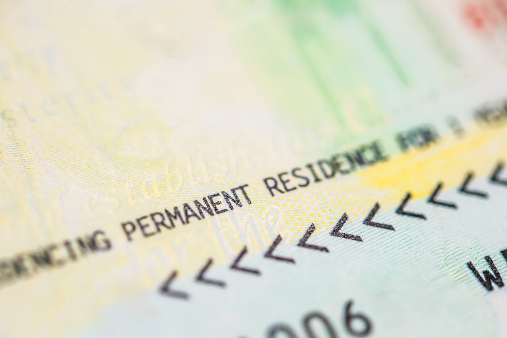 Close-up of a U.S. permanent resident card showing printed text.