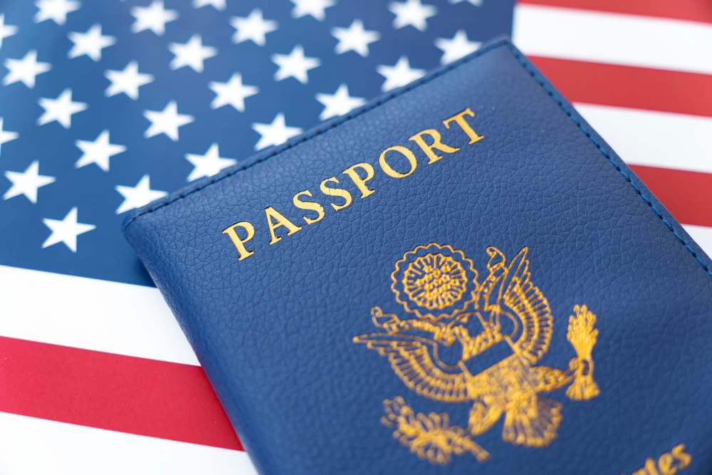 United States passport resting on an American flag.